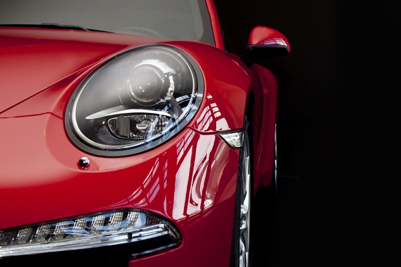 front right headlight and bumper of a red European car